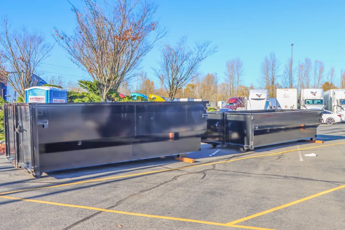 Professional dumpster rental service with roll-off container on residential driveway in La Vista